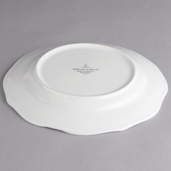 A white Villeroy & Boch porcelain plate with a curved edge.