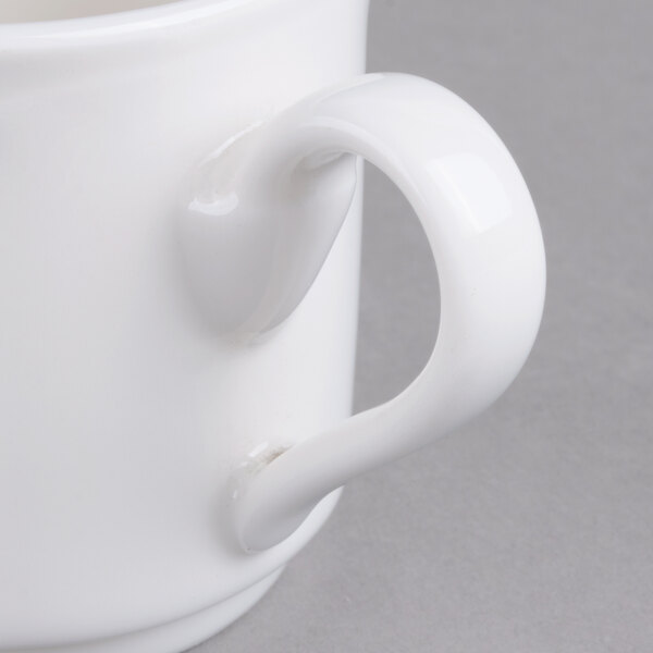 A close-up of a white Villeroy & Boch La Scala porcelain coffee mug with a handle.