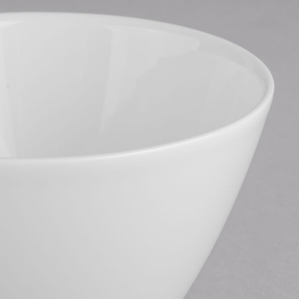 A close-up of a Villeroy & Boch white porcelain gourmet bowl with a white rim.