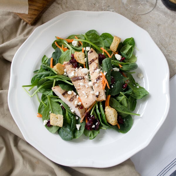 A white porcelain Villeroy & Boch La Scala round platter with a salad with grilled chicken.