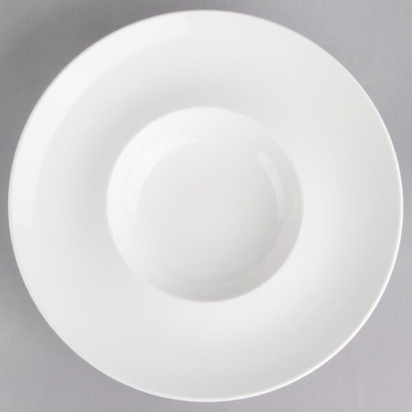 A white porcelain Villeroy & Boch deep plate with a white rim and a hole in the middle.