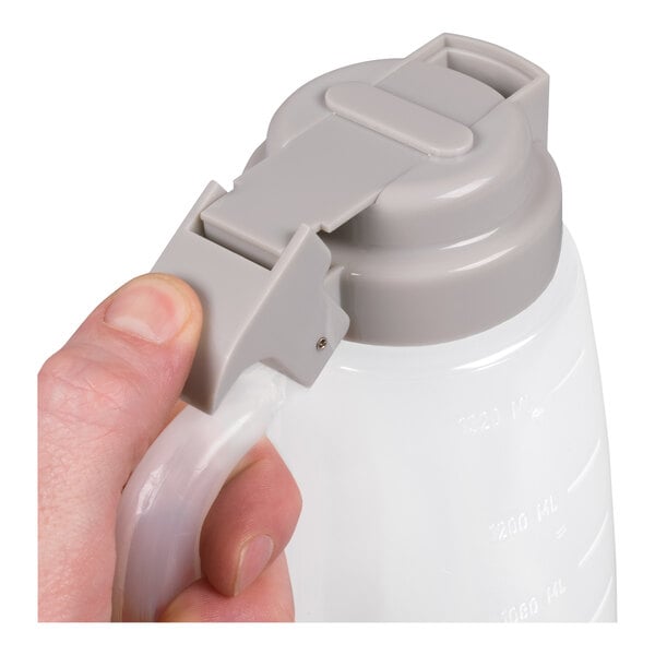 A plastic dispenser jar with a gray flip-top lid and handle.