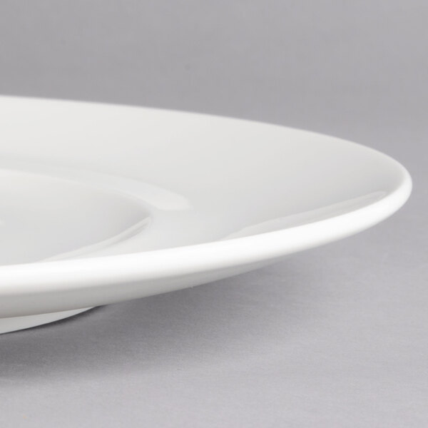 A close-up of a white Villeroy & Boch porcelain flat plate with a small rim.