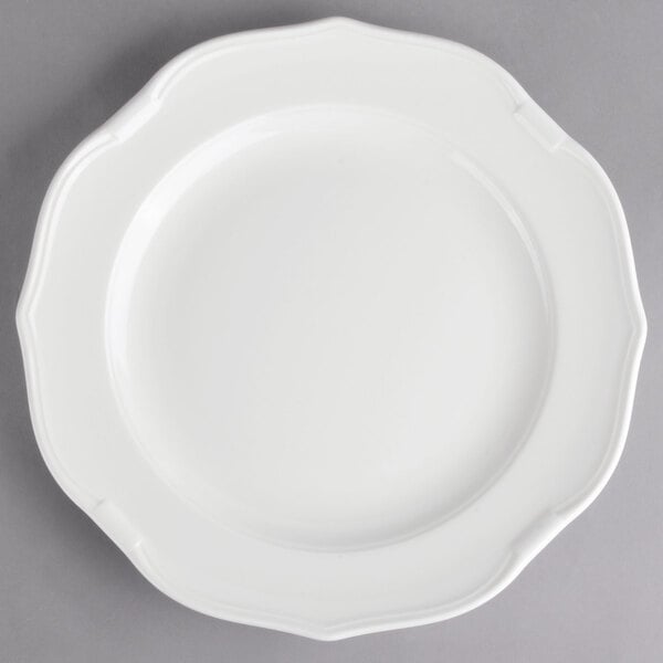 A Villeroy & Boch white porcelain plate with a scalloped edge.