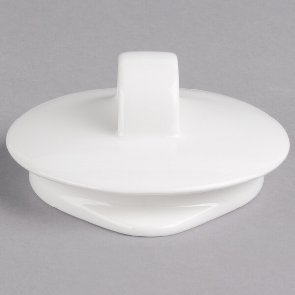 A white porcelain teapot with a white lid and a handle.