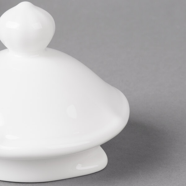 A white ceramic lid with a round top.