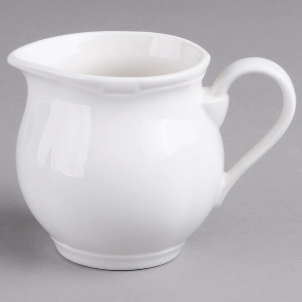 A white pitcher with a handle.