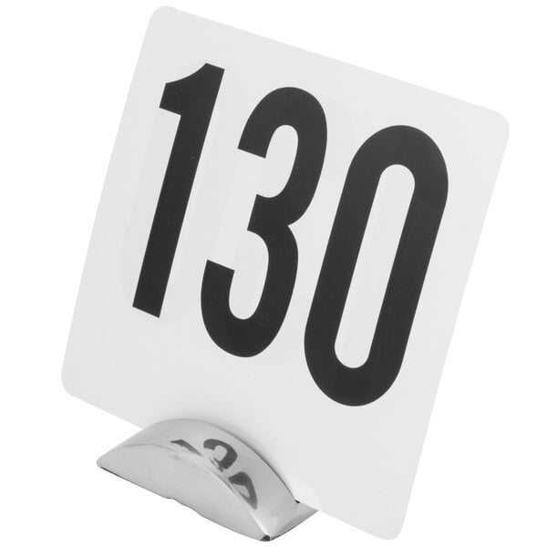 A stainless steel single wave table card holder with a white sign and black numbers on it.