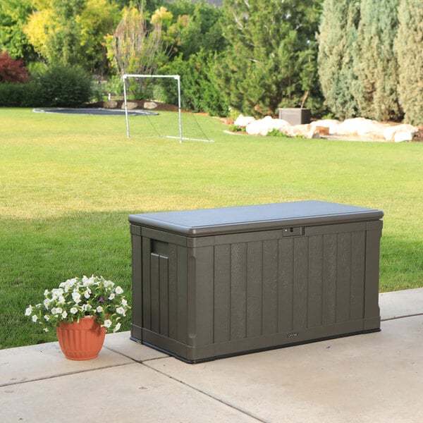 Lifetime brown outdoor storage box with a large yard in the back