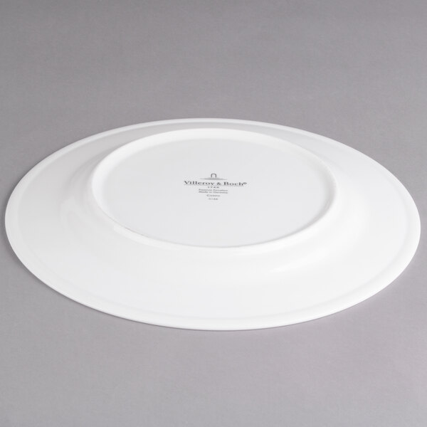 A Villeroy & Boch white porcelain flat plate with a white rim.