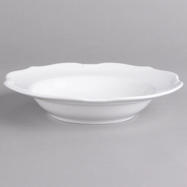 A white porcelain bowl with a scalloped edge.