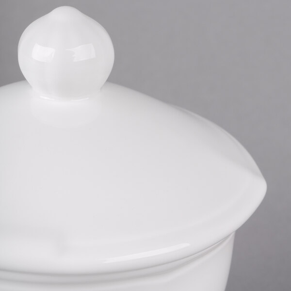 A white ceramic Villeroy & Boch covered sugar bowl on a white surface.