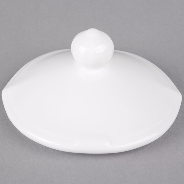 A white porcelain lid with a round knob.