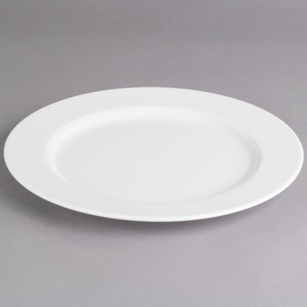 A white Villeroy & Boch porcelain flat plate with a rim on a gray surface.