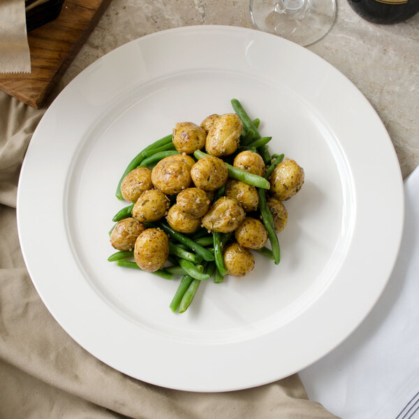 A Villeroy & Boch white porcelain round platter with food on it on a table.