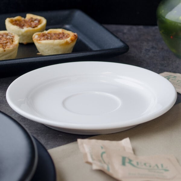 A Villeroy & Boch white porcelain saucer with food and a drink on it.