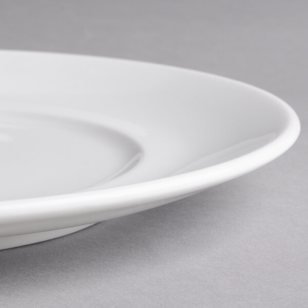 A close-up of a Villeroy & Boch white porcelain flat plate with a rim.