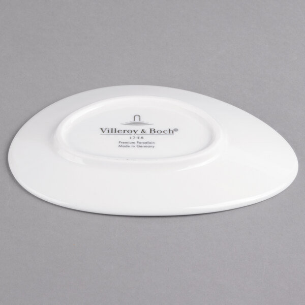 A white Villeroy & Boch porcelain oval plate with black text on it.