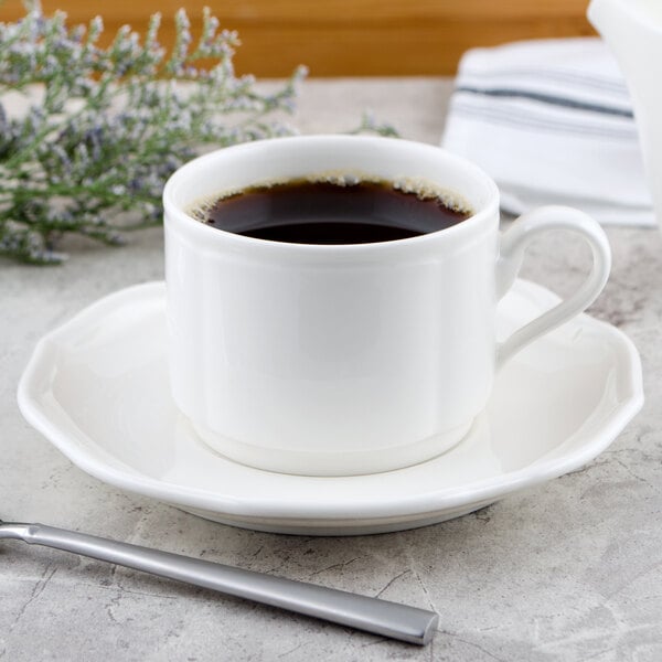 A Villeroy & Boch white porcelain saucer with a cup of coffee on it.