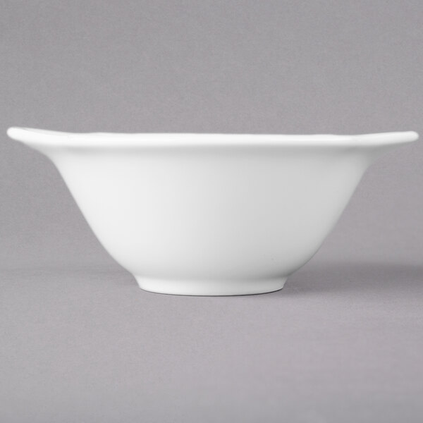 A white porcelain soup cup with a handle.