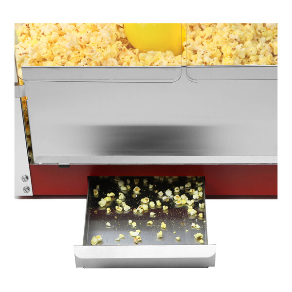 A red Paragon Theater Pop popcorn machine with popcorn in it on a counter.
