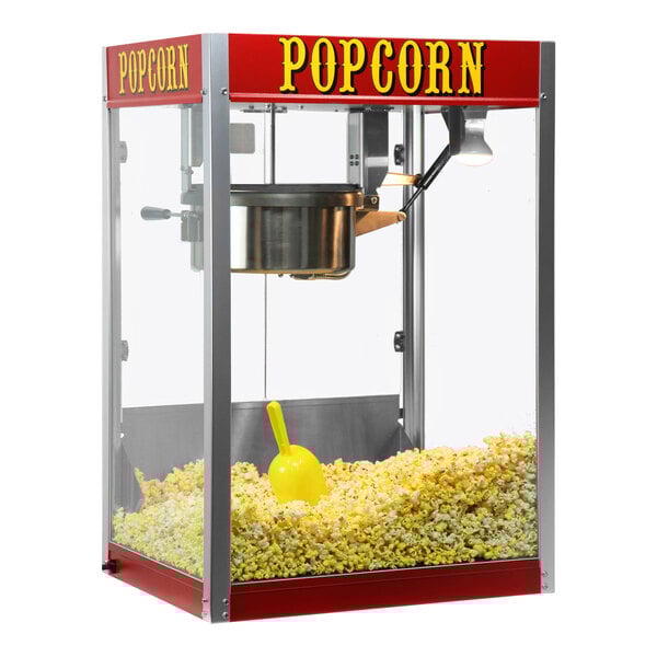 A red Paragon Theater Pop popcorn machine with a large container of popcorn.