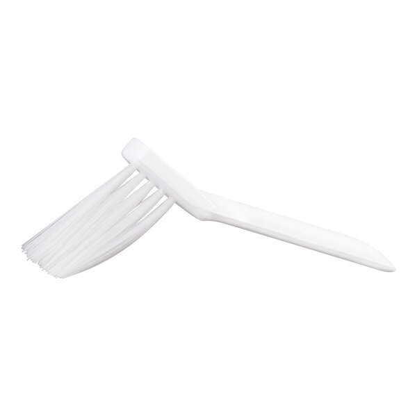 A white brush with stiff, angled bristles and a long handle.