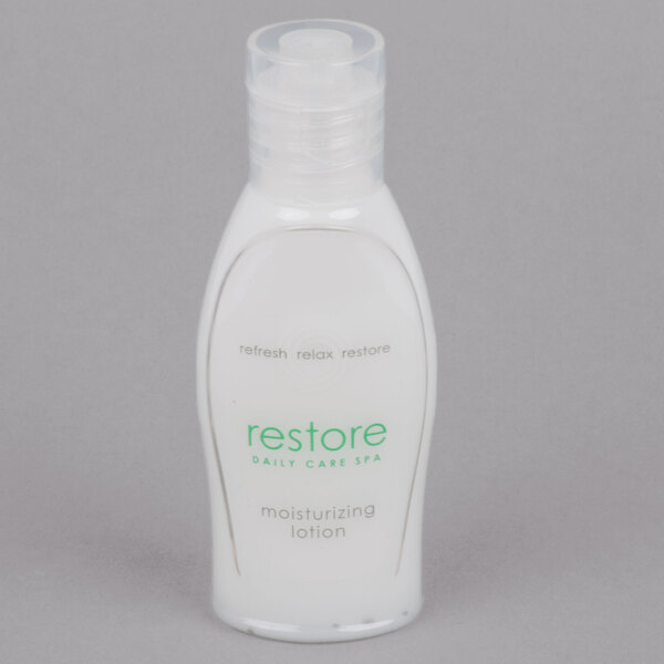A white Dial bottle of Restore hand and body lotion with green text.