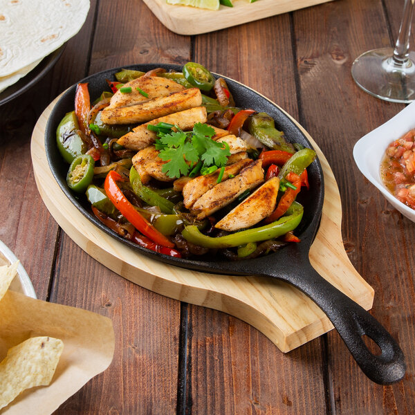 Cast iron skillet filled with grilled chicken and roasted vegetables