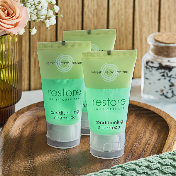 A close-up of a green plastic bottle of Dial Restore Conditioning Shampoo.