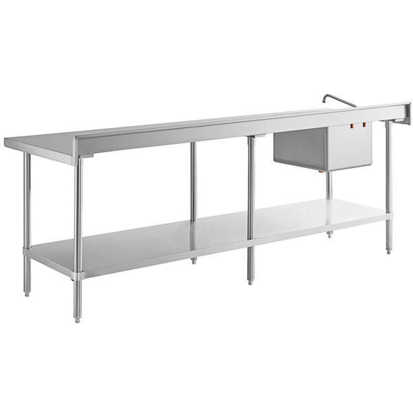 A long stainless steel work table with an integrated sink and faucet on the left side and a lower storage shelf.