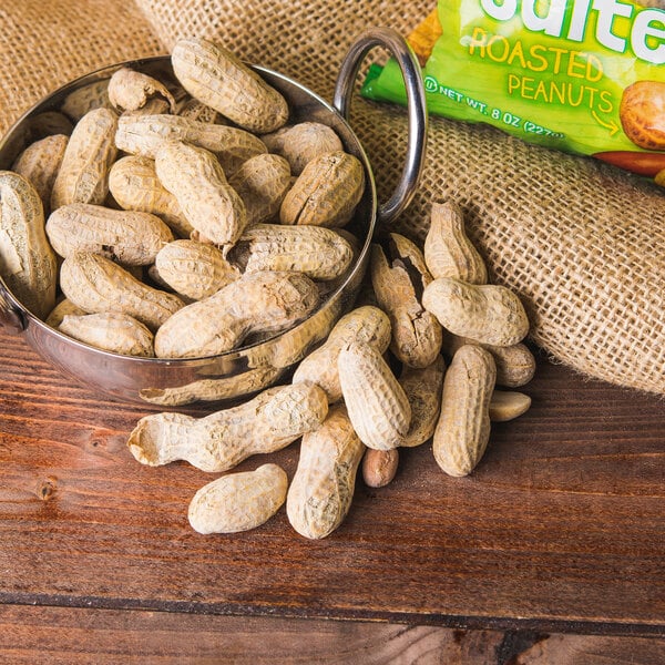 A bowl of Hampton Farms in-shell peanuts on a table.