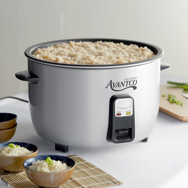 An Avantco electric rice cooker with a bowl of rice and green garnish.