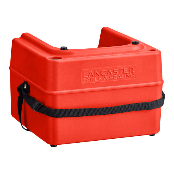 A red plastic Lancaster Table & Seating booster seat with a black strap.