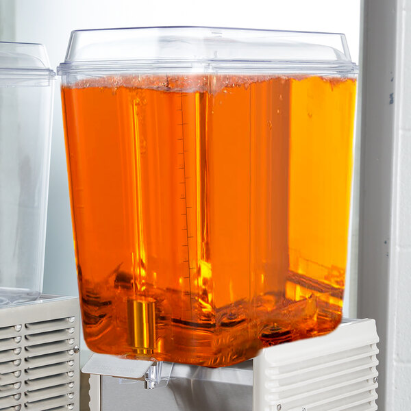 A Crathco refrigerated beverage dispenser bowl filled with orange liquid.