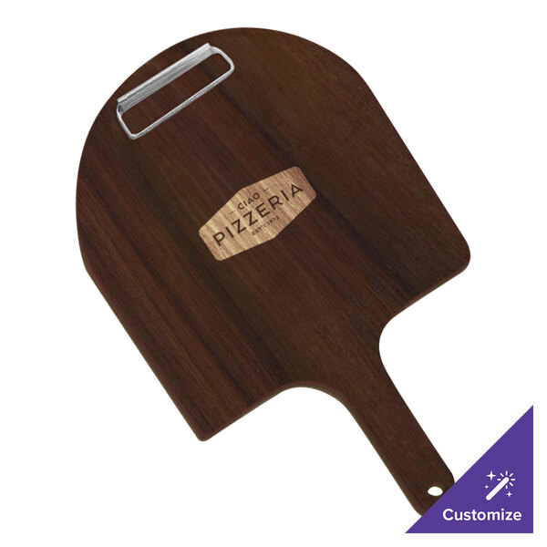 A walnut pizza peel with a wooden handle on a table.