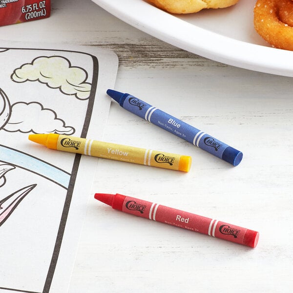 A yellow tube with white text containing a group of Choice Kids' Restaurant Crayons on a table with a plate of food and a donut.