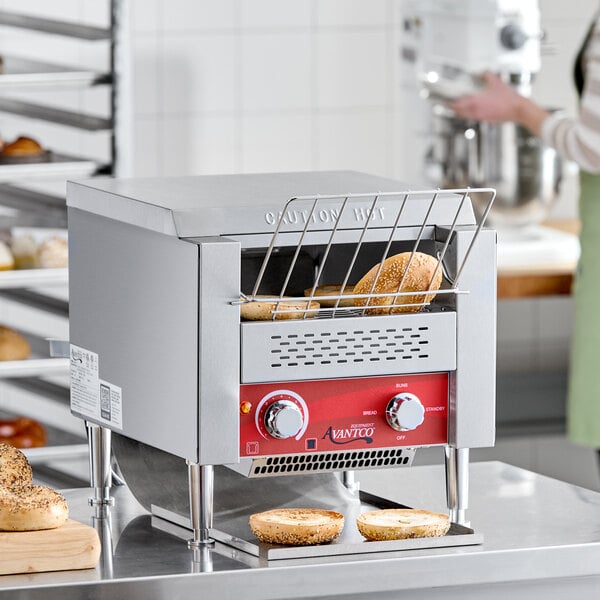 A commercial conveyor toaster with a 3-inch opening, designed for toasting bagels and bread, shown in a bakery setting.