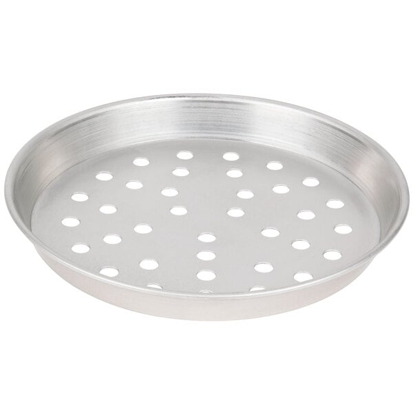 A silver round metal pan with holes.
