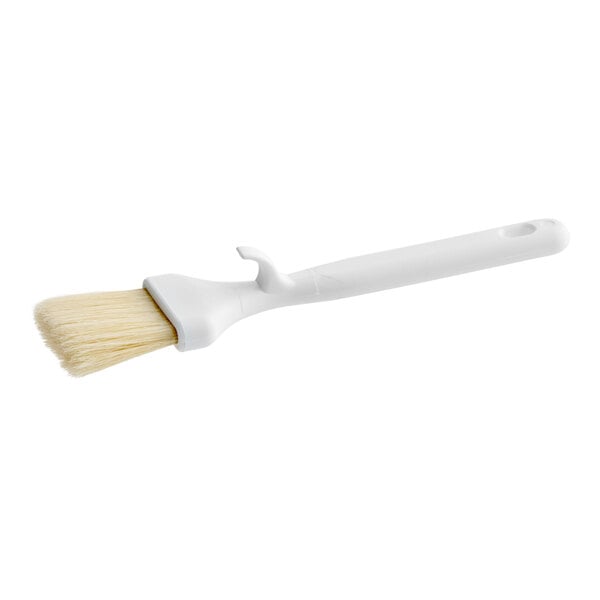 A white Carlisle Sparta Spectrum pastry brush with a curved white plastic handle.