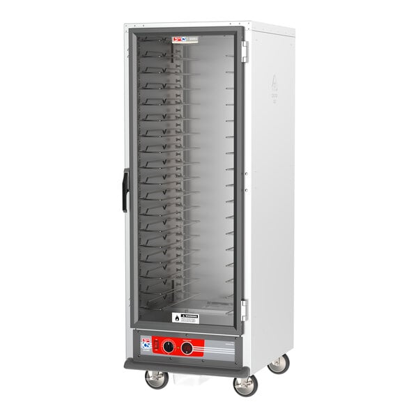 A white Metro C5 holding cabinet with clear doors and wheels.