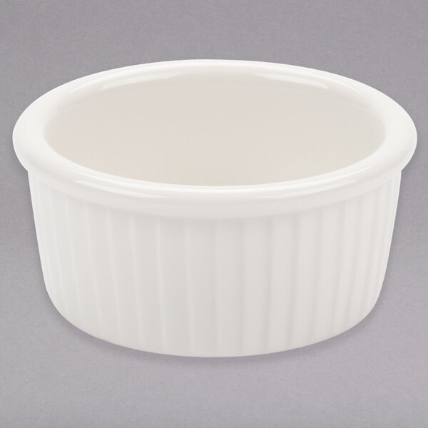 A white ceramic Tuxton fluted ramekin with a ribbed rim.