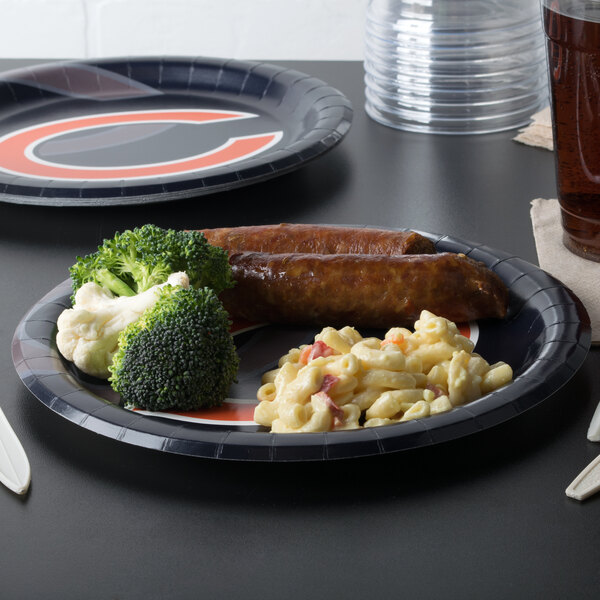 A table with a Creative Converting Chicago Bears paper dinner plate filled with food.