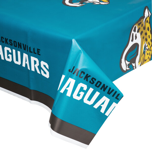 A blue plastic table cover with the Jacksonville Jaguars logo and a leopard print border.