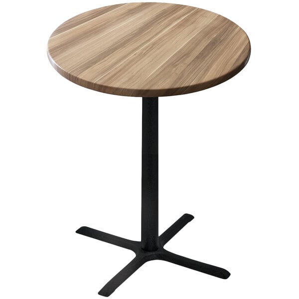 A round wooden table with a black cross base.