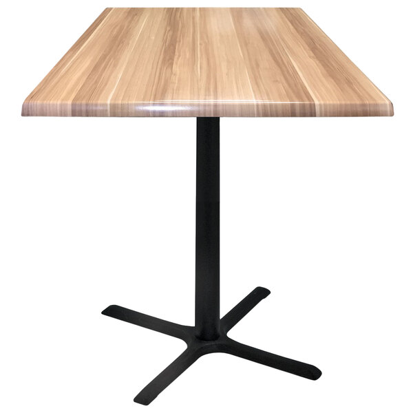 A Holland Bar Stool natural wood table top with a black cross base.