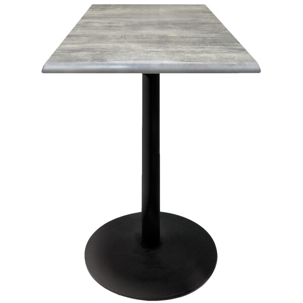 A Holland Bar Stool outdoor table with a gray stone top and black round base.