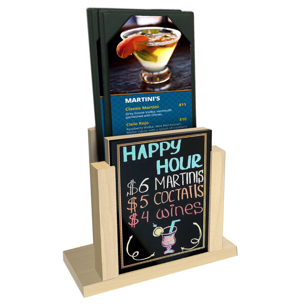 A natural wood menu holder with a wet erase board insert on a table with a drink.