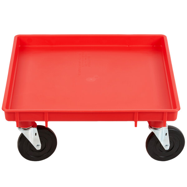 A red plastic Vollrath Traex dolly base with black wheels.