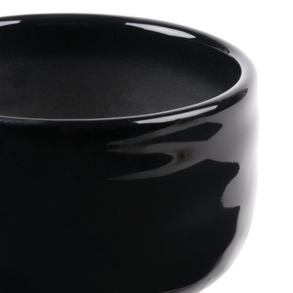 A close-up of a black Reserve by Libbey Pebblebrook porcelain bouillon bowl.